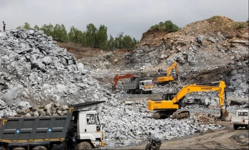 Heavy rock breaking crawler excavator at site