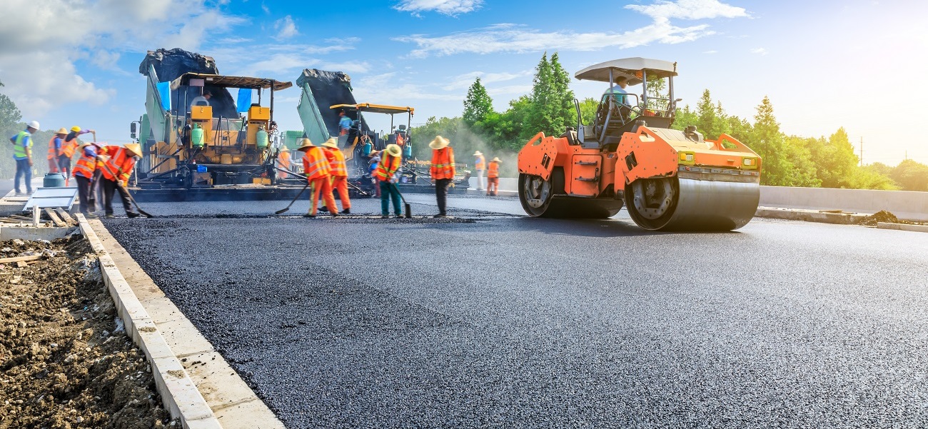 Dump truck and excavator at road work